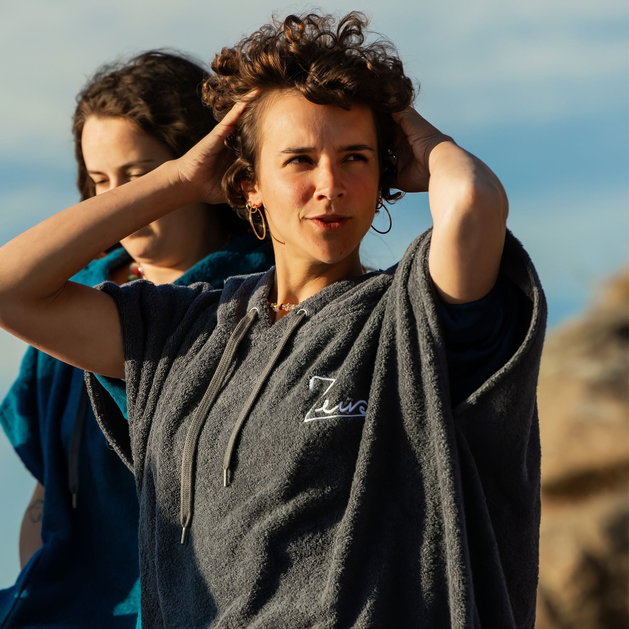 a woman holding her hair in the wind