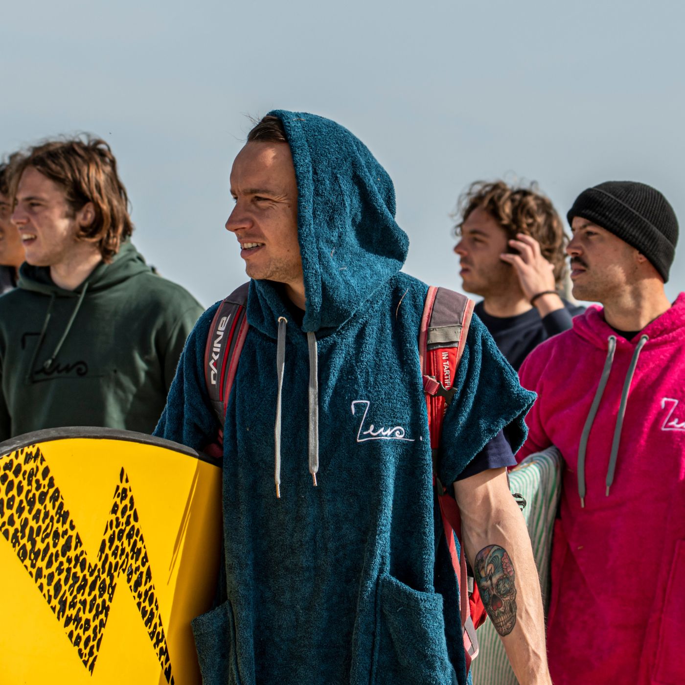 a group of men standing next to each other holding surfboards