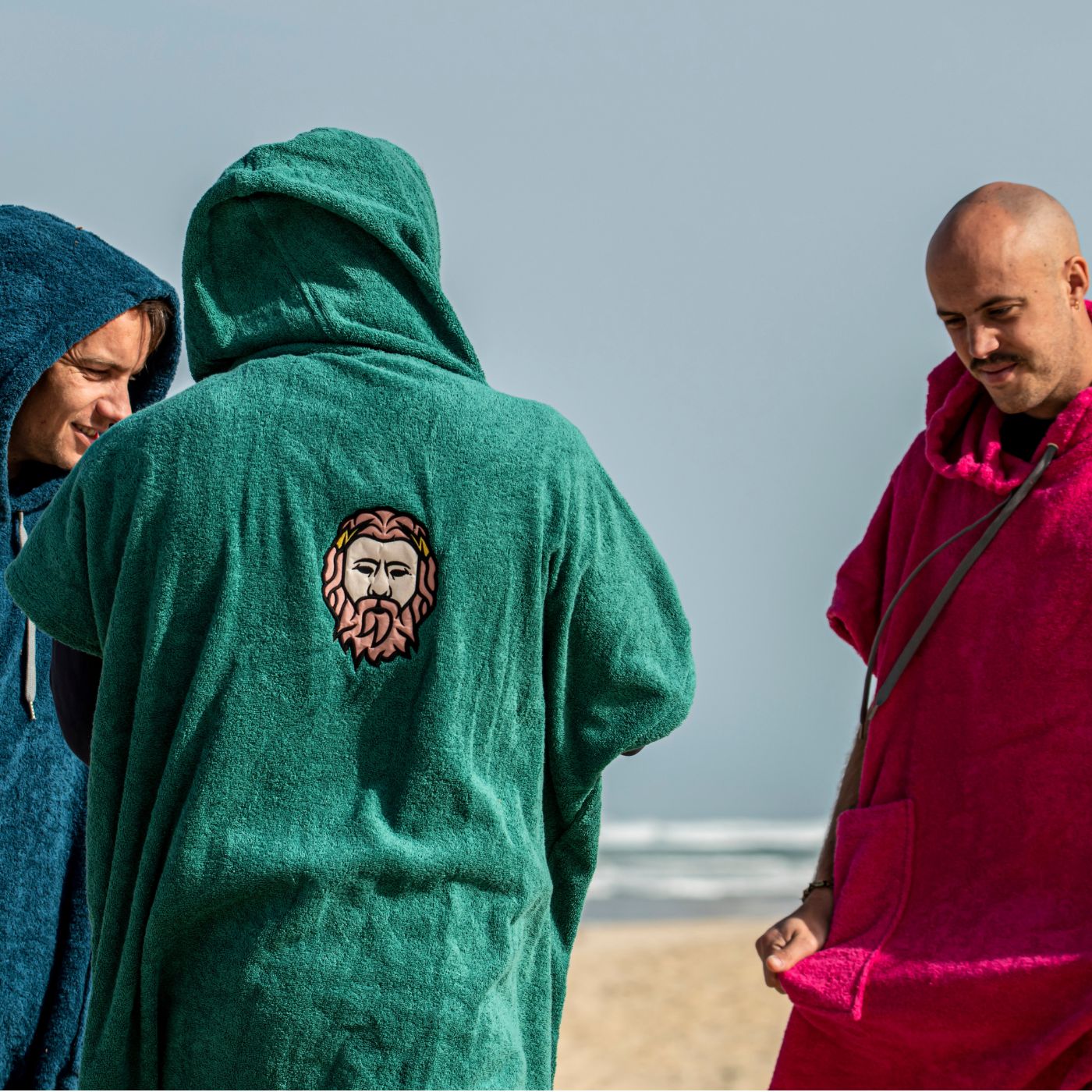 a group of men standing next to each other on a beach