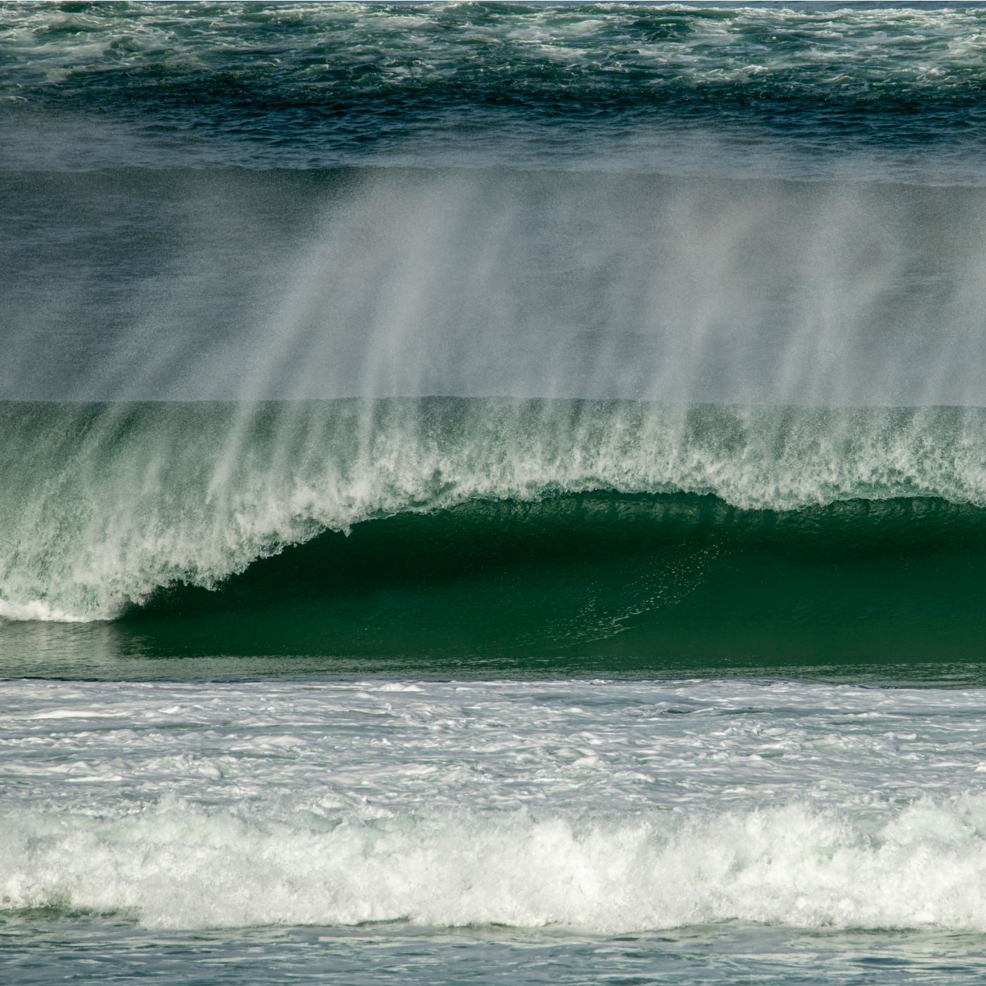 a man riding a wave on top of a surfboard