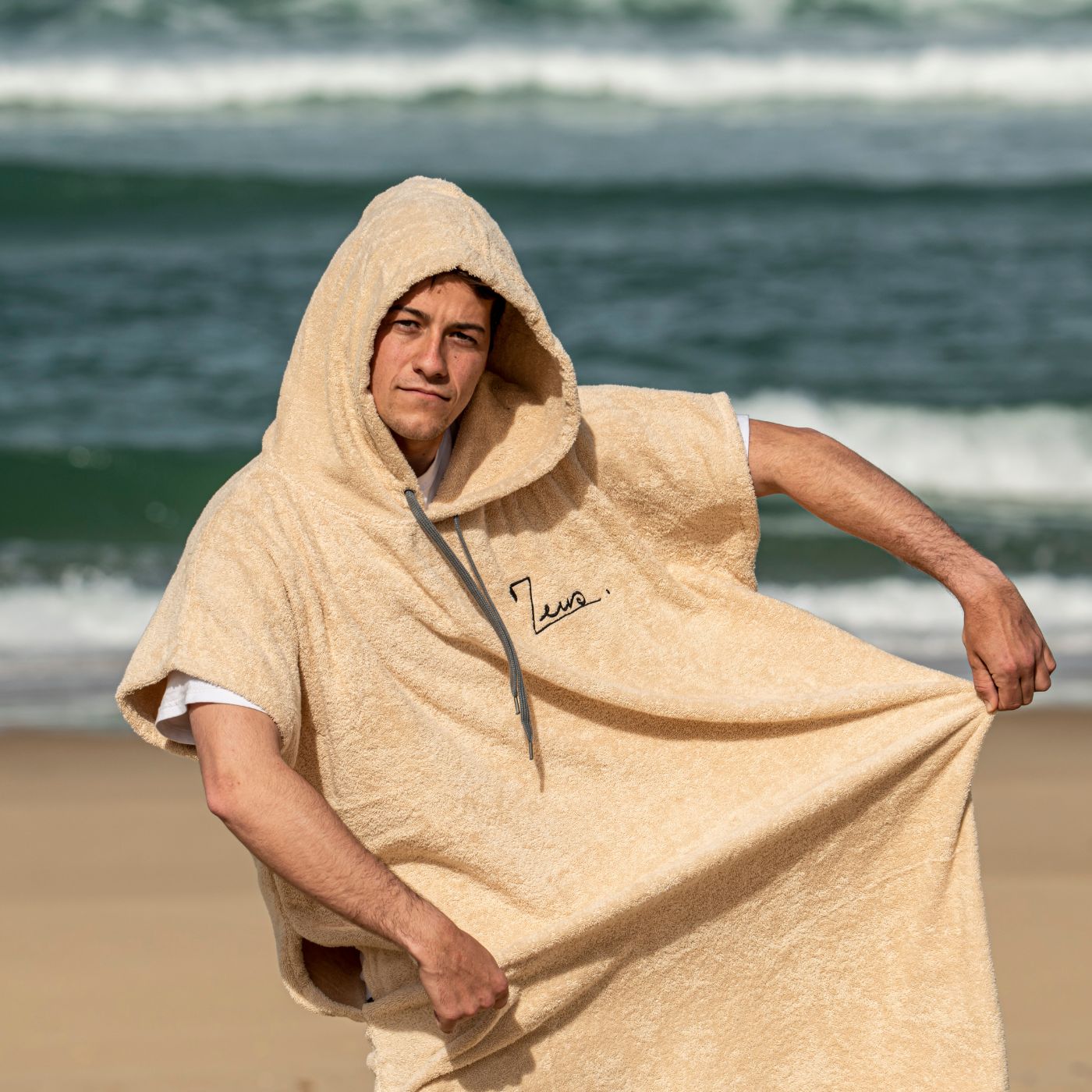 a man wrapped in a towel on the beach